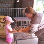 Kathy Landers helping my daughter hold a baby turkey